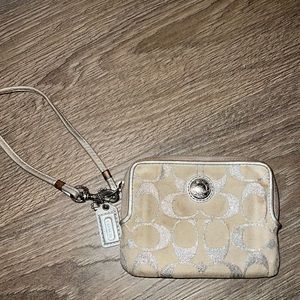 Silver Coach wristlet. Slight discoloration.